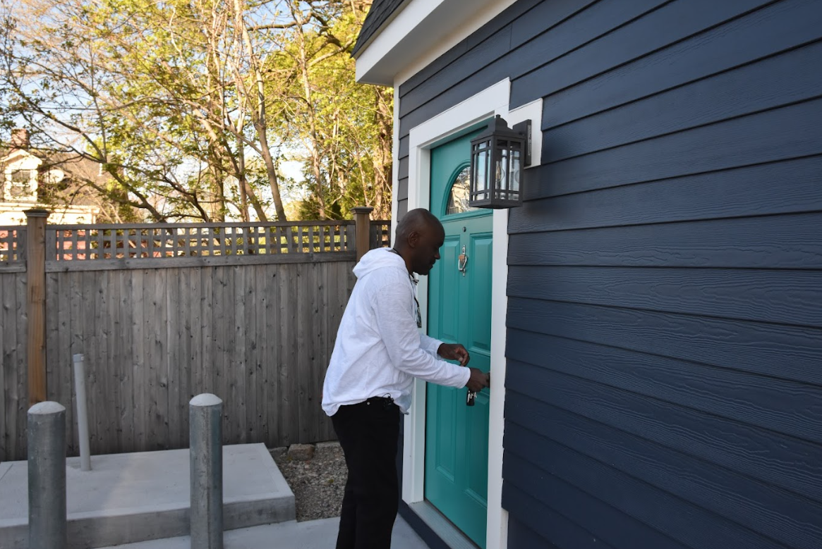 Homeowner unlocks the door of his detached garage ADU.