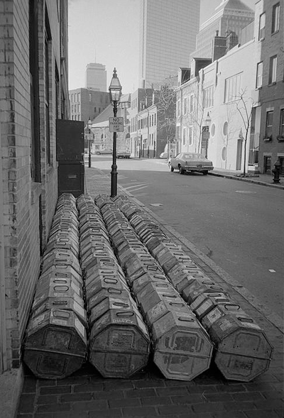 Motion picture film cans ready for shipping in Bay Village, Boston 1974. Photo courtesy of Boston Public Library