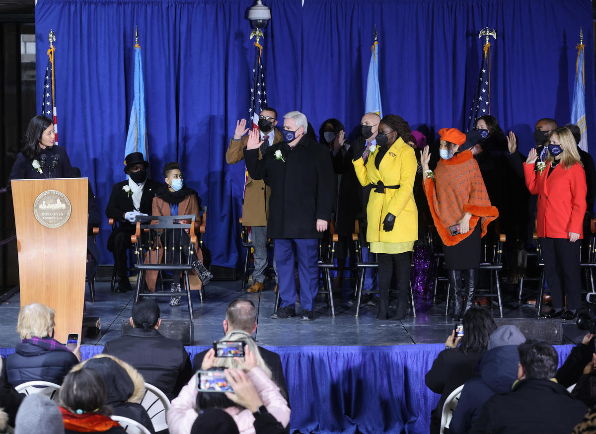 Mayor Wu swears in Boston City Councilors who are standing and raising their right hands.
