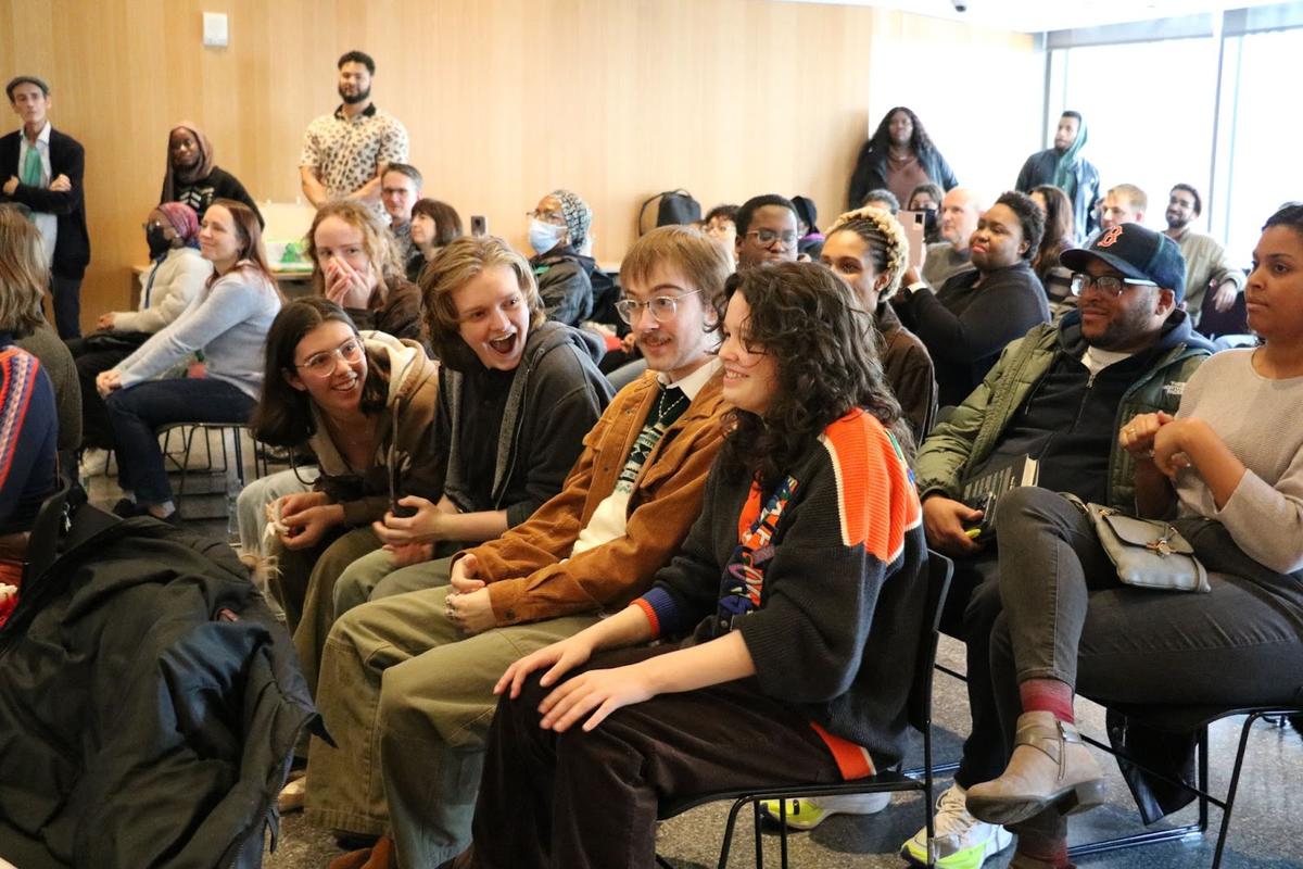 Boston’s third Youth Poet Laureate, Parker-Vincent Alva (right, with his hands on his knees, wearing an orange and black jacket) finds out that he has been selected as the next Youth Poet Laureate.
