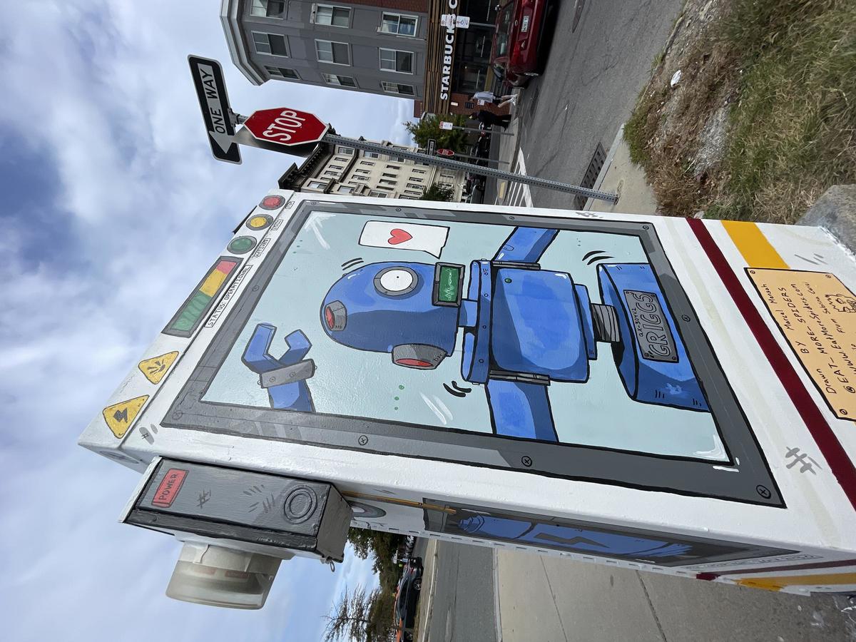 Painted utility box with a robot waving through a window