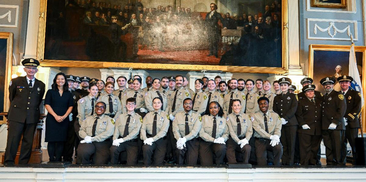 Mayor Michelle Wu and Boston EMS Chief James Hooley (left) with new EMTs and promoted staff.