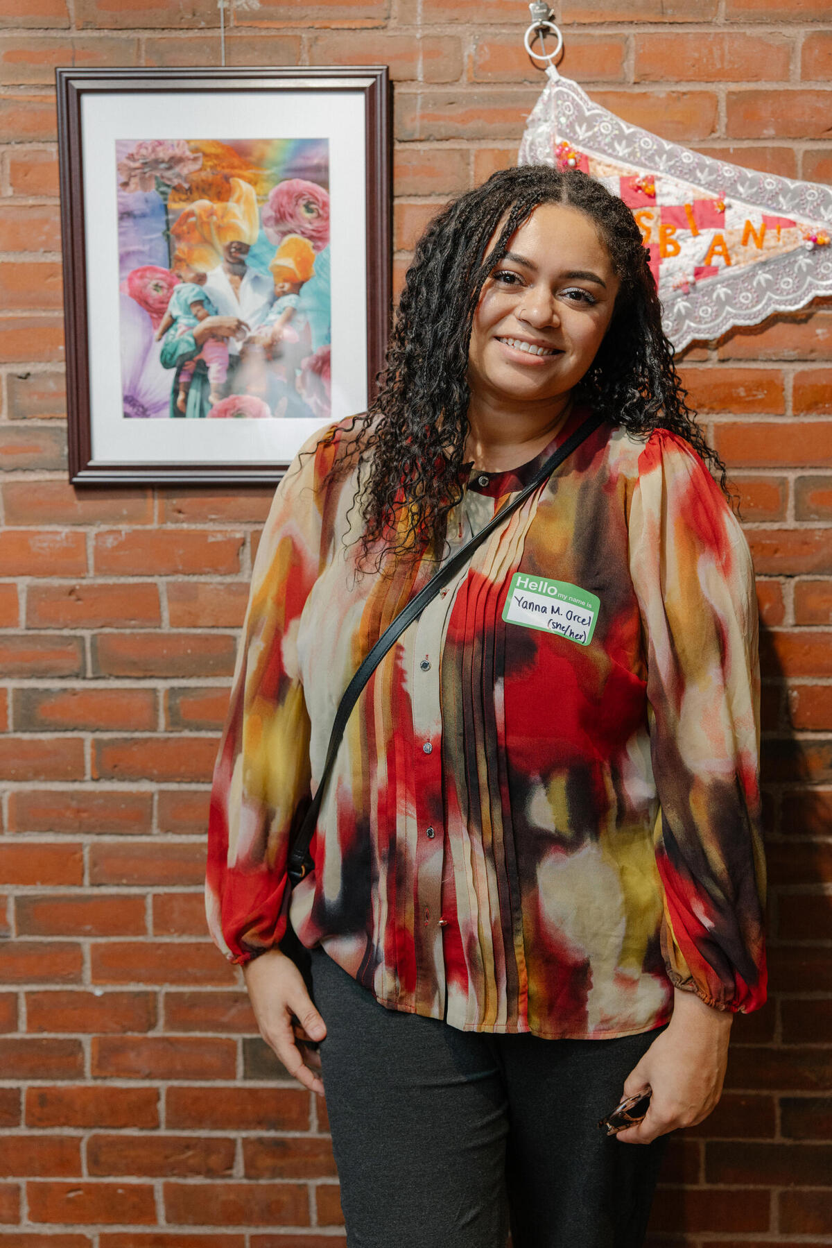 Yanna Marie Orcel standing with her winning artwork, Mother's Garden, 2023, Collage, 14 x 11 in.&nbsp;