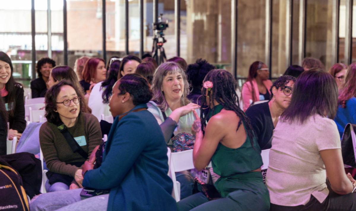 Women sitting in the Mezzanine of City Hall talking