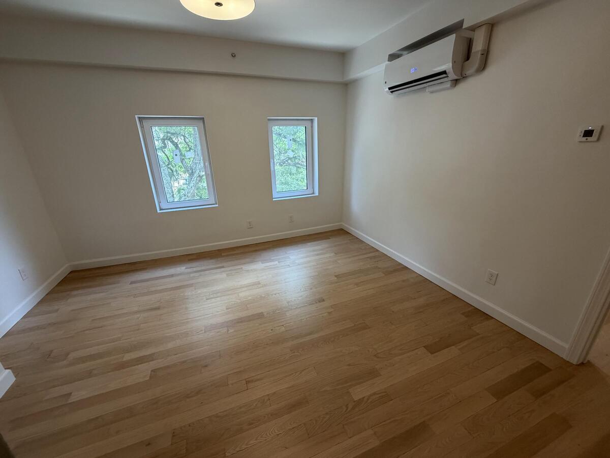 Large and bright room with hardwood floors.