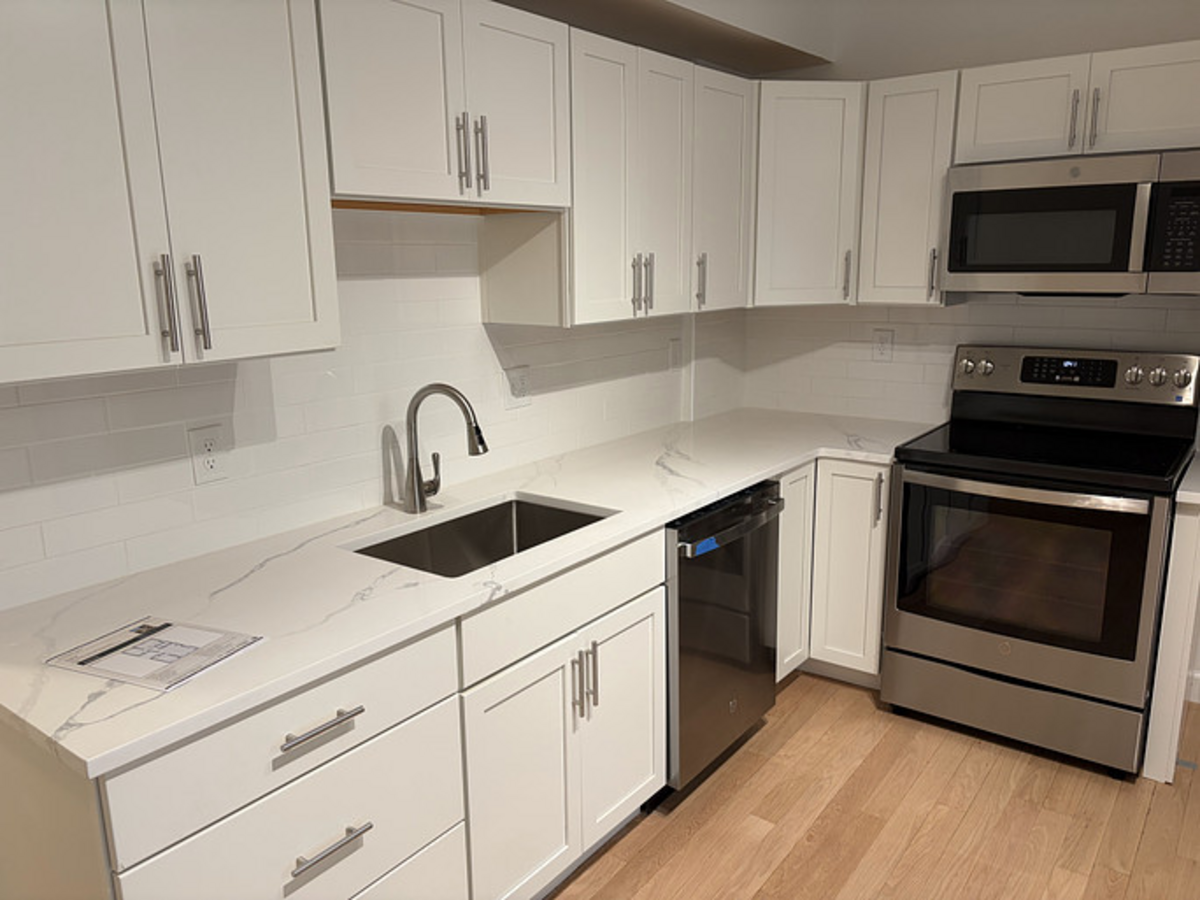 Bright, spacious kitchen with stainless steel appliances.