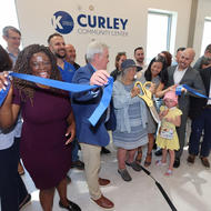 People cutting the ribbon to reopen BCYF Curley