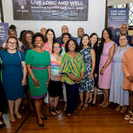 Mayor Michelle Wu and Commissioner of Public Health for the City of Boston Dr. Bisola Ojikutu join community partners for a photo.