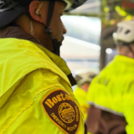 Side profile of EMS worker in yellow work jacket