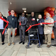 Developers, MOH staff, and new residents celebrate the ribbon cutting at 59 Bartlett Station